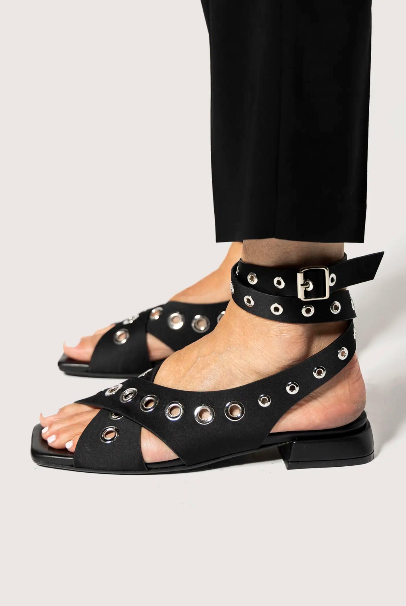 swatch_black satin flat sandal with grommets flat sandals