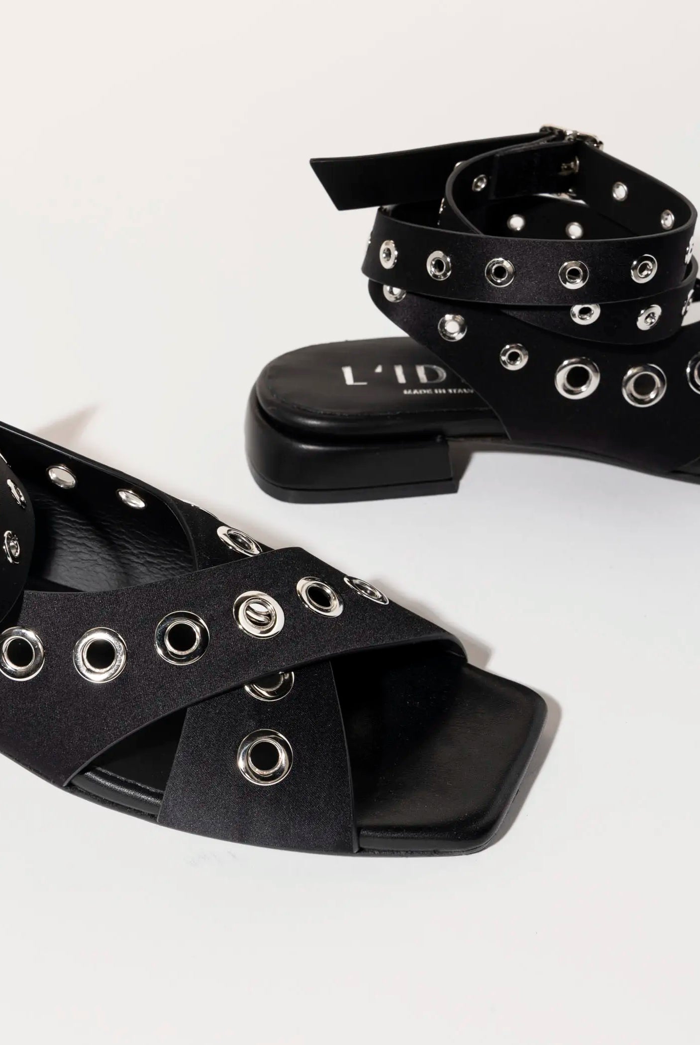 swatch_black satin flat sandal with grommets flat sandals