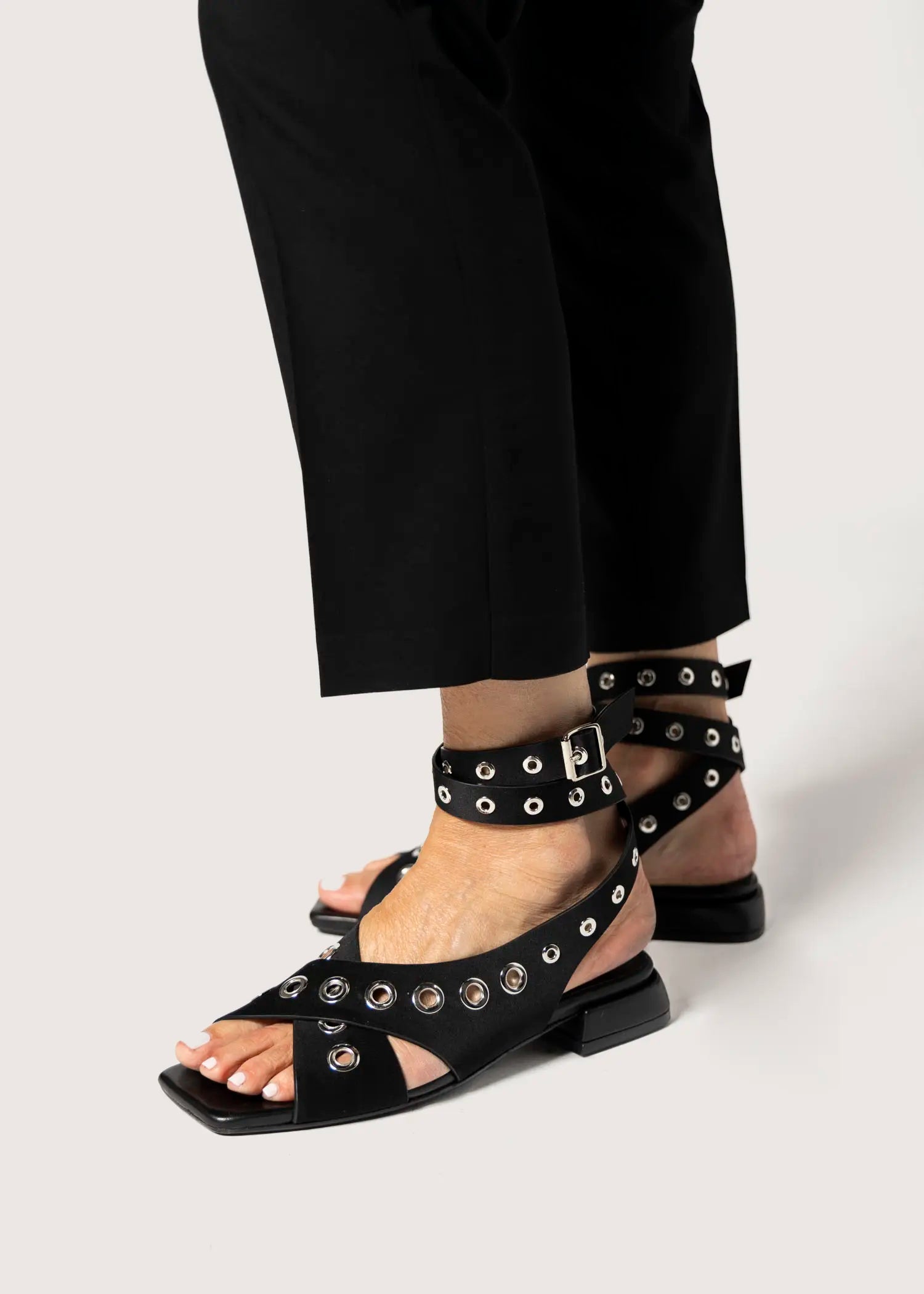 swatch_black satin flat sandal with grommets flat sandals