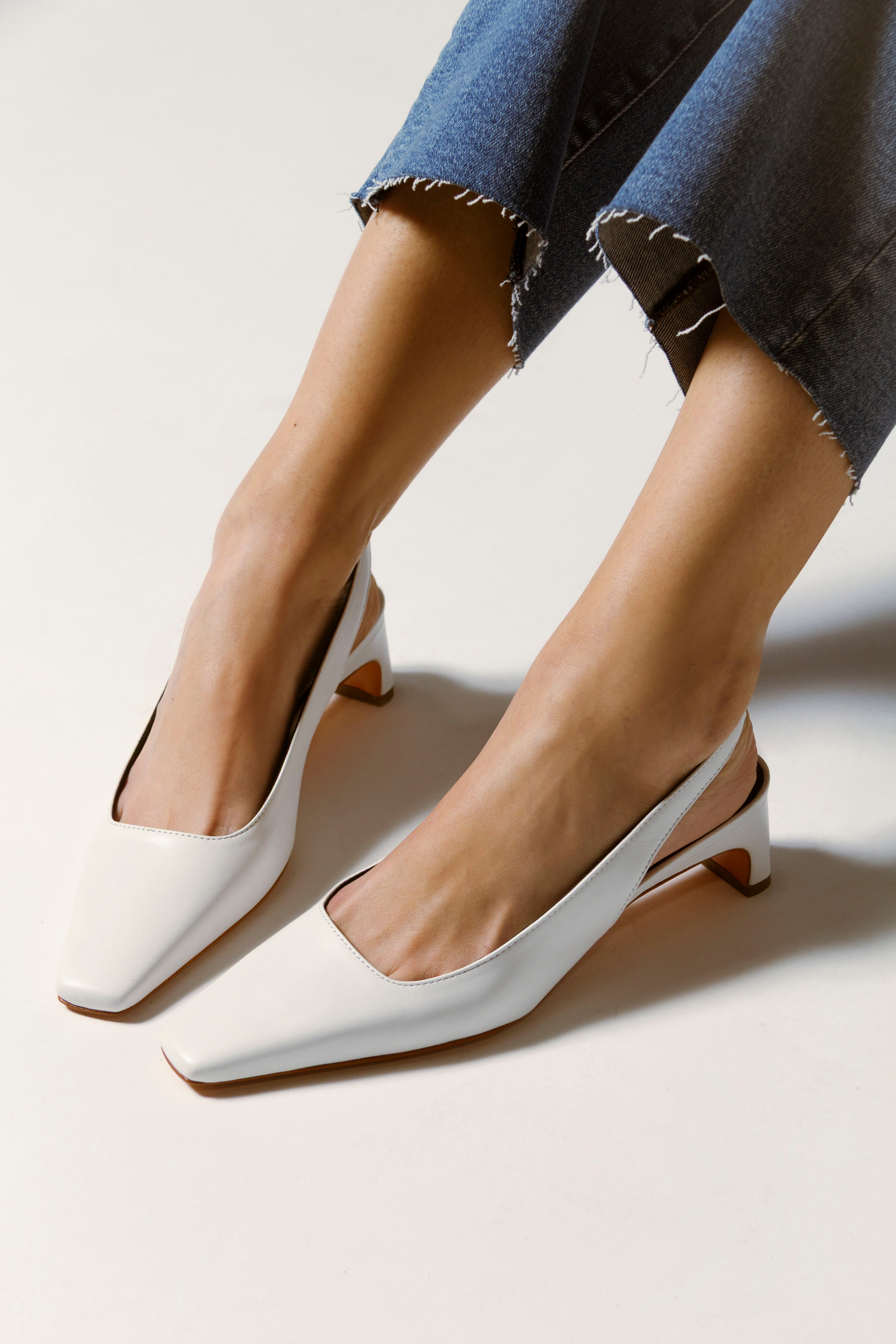 Image of white slingback heels with a link to shop all pumps