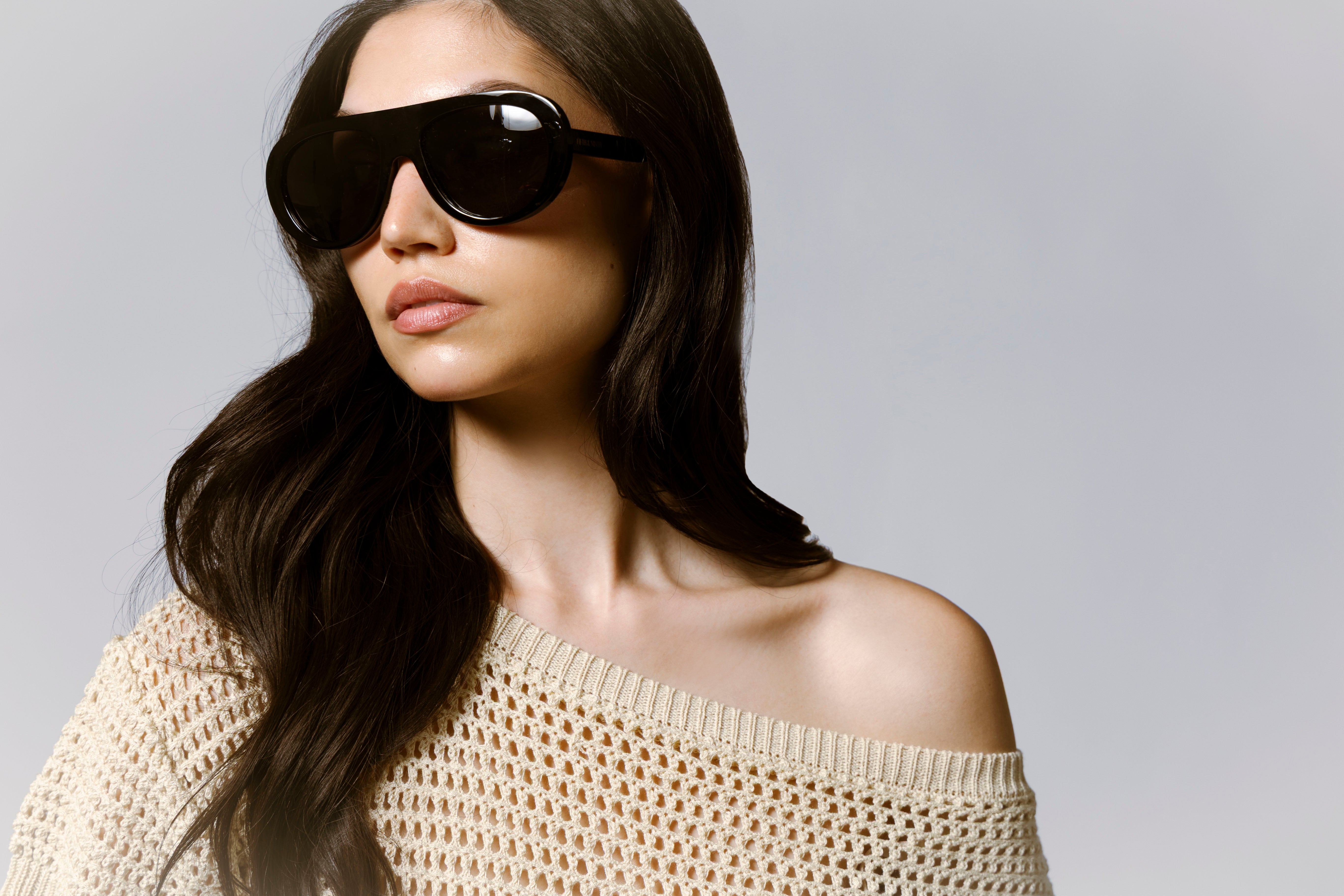 woman wearing sunglasses and off the shoulder knit dress with link to shop new arrivals