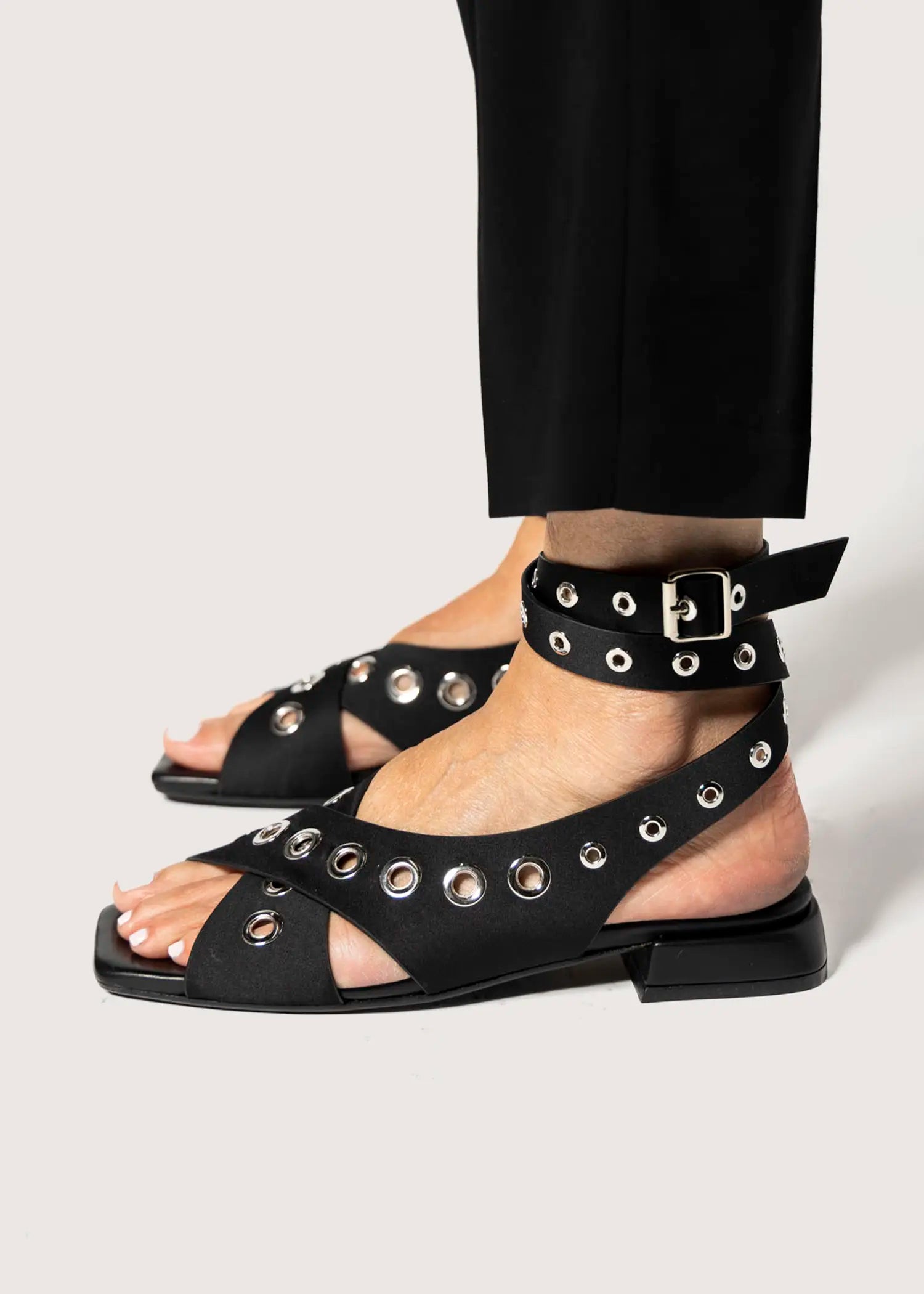 swatch_black satin flat sandal with grommets flat sandals