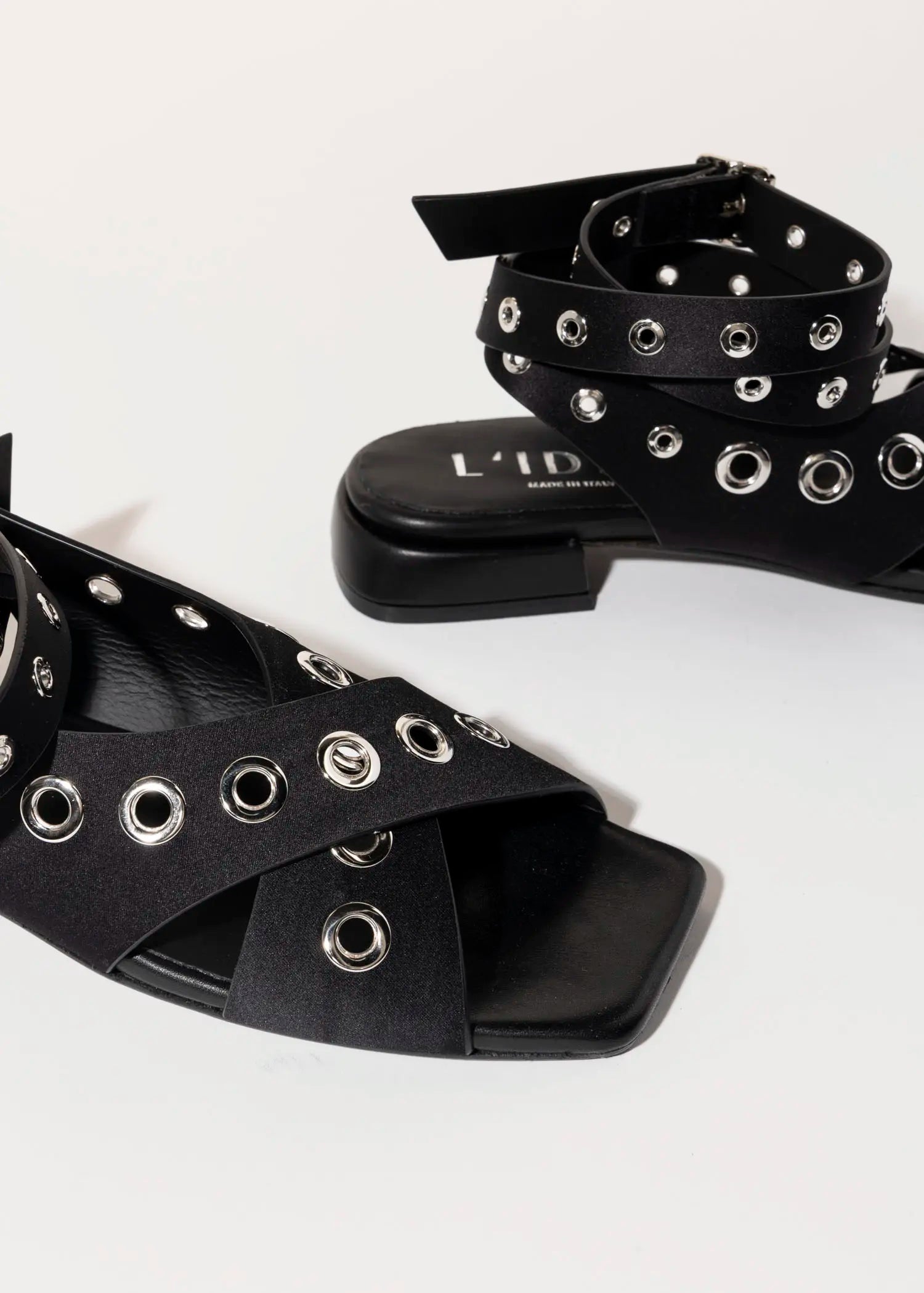 swatch_black satin flat sandal with grommets flat sandals